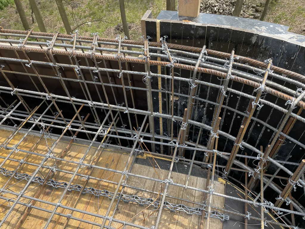 Detal łukowego zbrojenia przy zaokrąglonej ścianie żelbetowej kondygnacji podziemnej