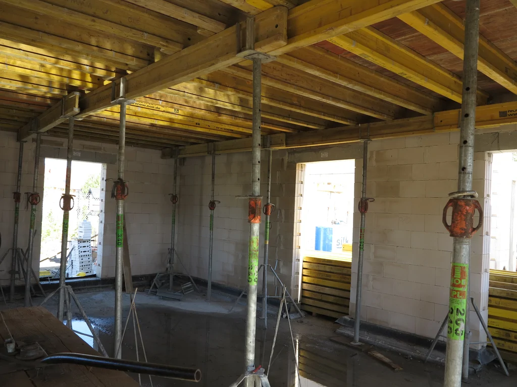 Wymurowane ściany z silikatów, widoczne stemple podpierające szalunek stropu 