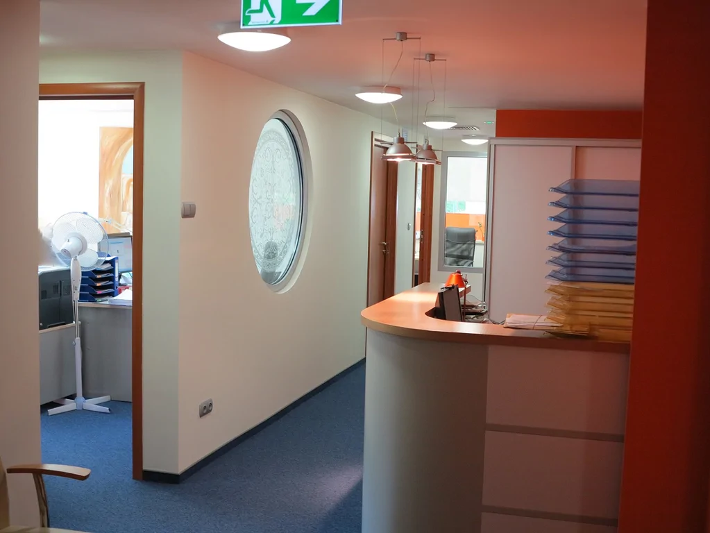 Widok na biuro w środku, witraż, narożnik, recepcja pomieszczenie z wiatrakiem i drukarką