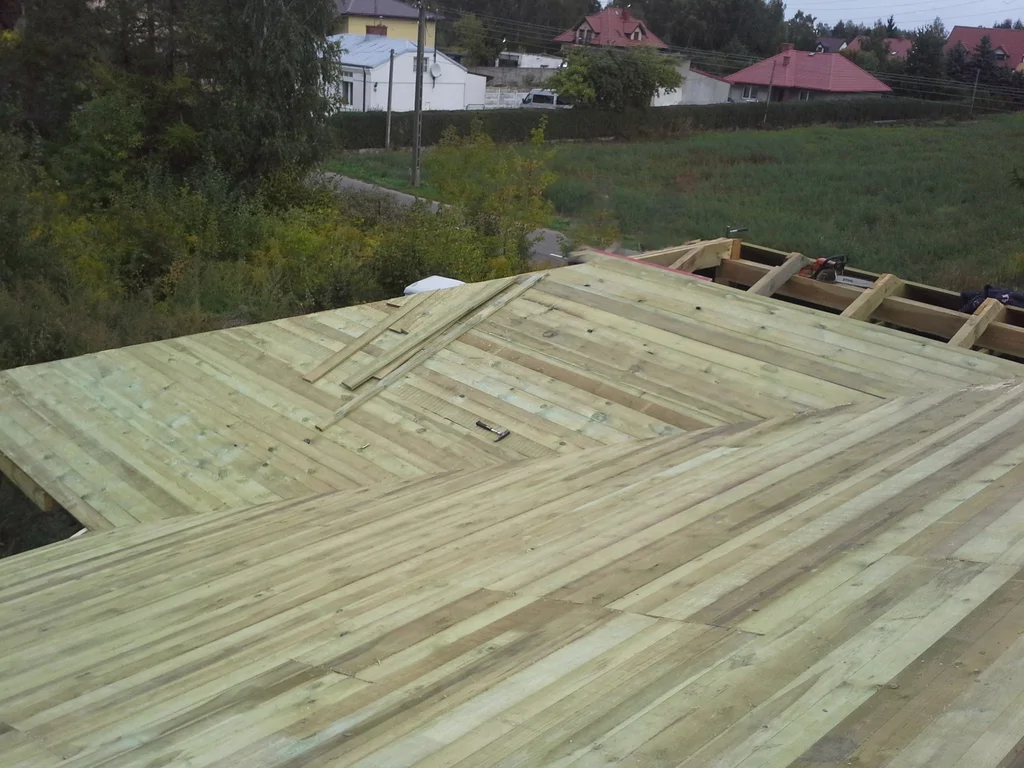 Więźba dachowa z deskowaniem na budowie domu jednorodzinnego 