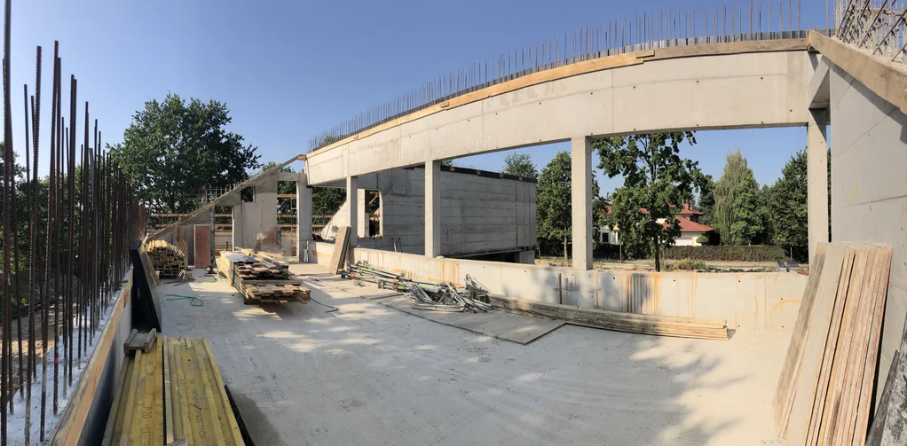 Piętro z elementem o łukowej linii i dużymi otworami – beton architektoniczny oraz przygotowanie pod strop żelbetowy po skosie