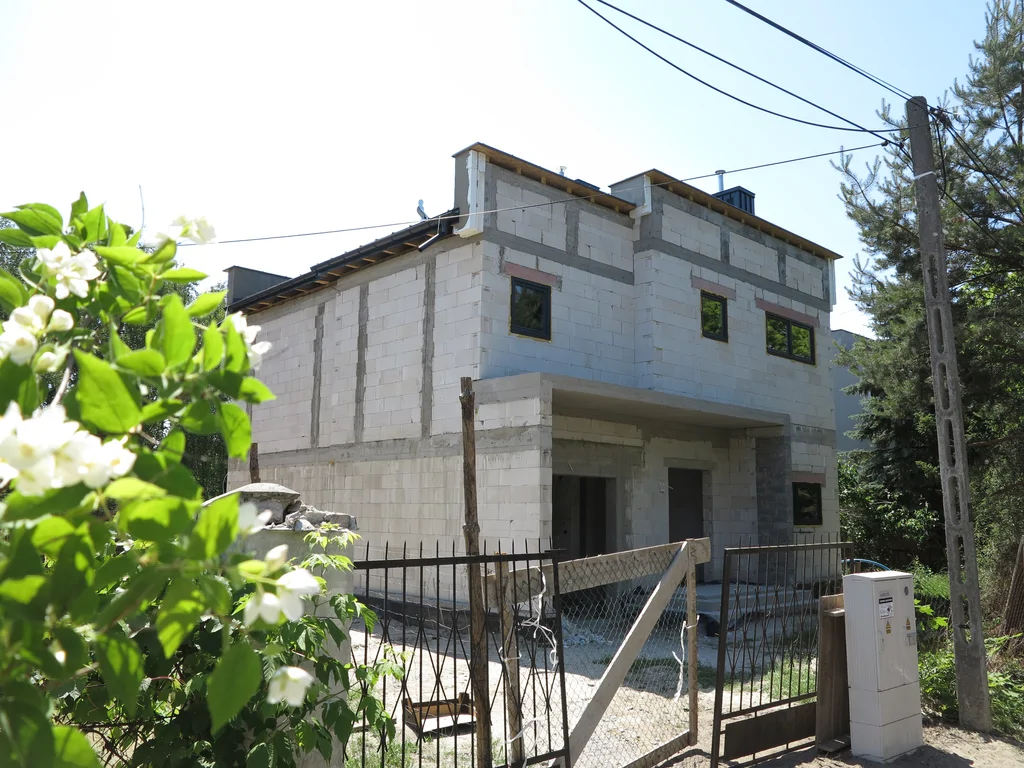 Widok na budynek jednorodzinny, ściany z silikatów , strefa wejścia i elementy konstrukcyjne z żelbetu